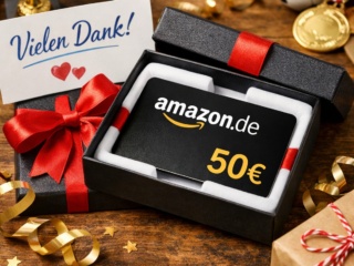 Ein Amazon-Gutschein als stilvolles Geschenk in einer schwarzen Geschenkbox mit roter Schleife, dazu eine Dankeskarte („Vielen Dank!“) auf einem Holztisch – warmes, wertschätzendes Motiv.